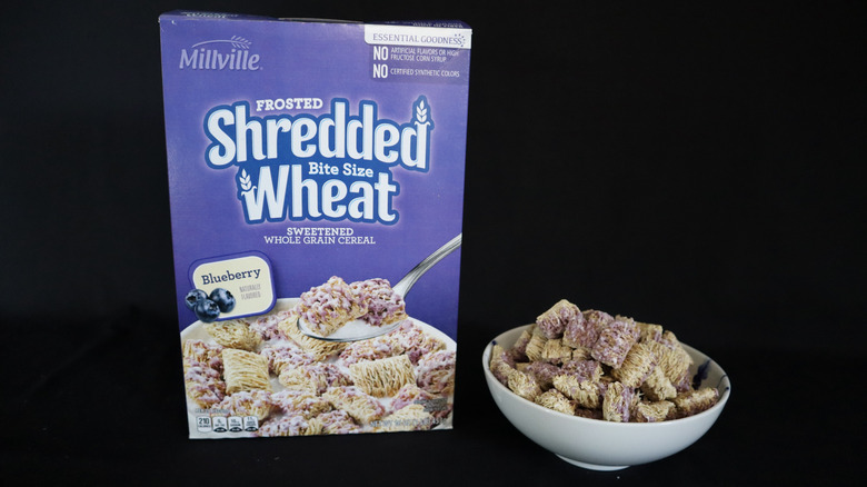 Blueberry Frosted Shredded Wheat box next to a bowl of cereal.