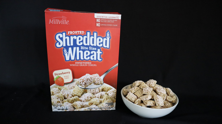 Strawberry Frosted Shredded Wheat box next to a bowl of cereal.