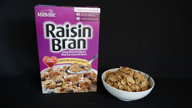 Raisin Bran box next to a bowl of cereal.