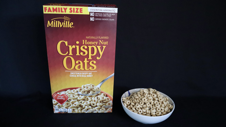 Honey Crispy Oats box next to a bowl of cereal.