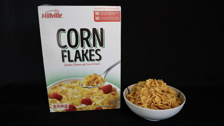 Corn Flakes box next to a bowl of cereal.