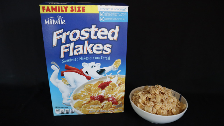 Frosted Flakes box next to a bowl of cereal.