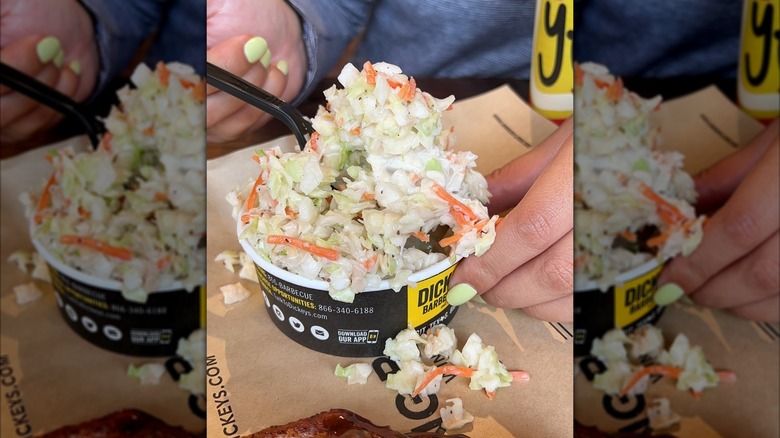 Person scooping Dickey's Barbecue Pit coleslaw out of paper cup