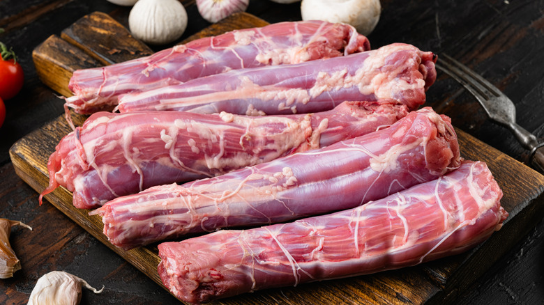 Raw chicken necks cutting board