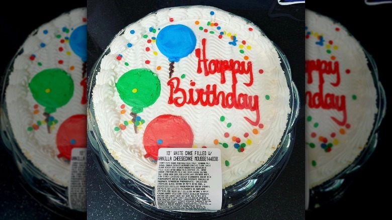 Round birthday cake with balloons