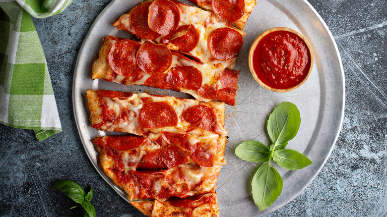 Pizza with side of marinara sauce