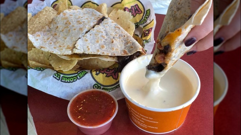 dipping Moe's quesadilla in queso