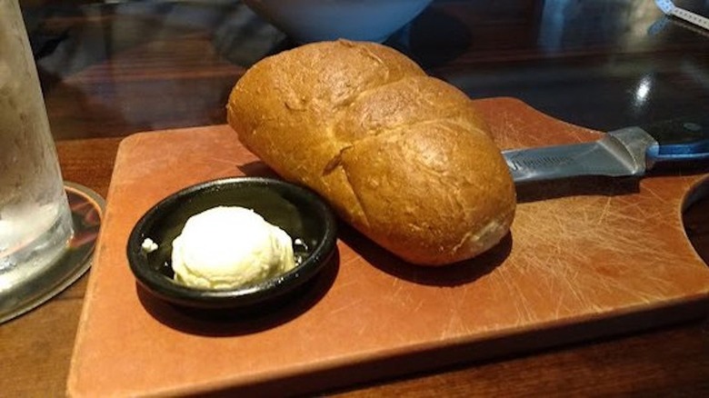 Bread loaf and butter on tray