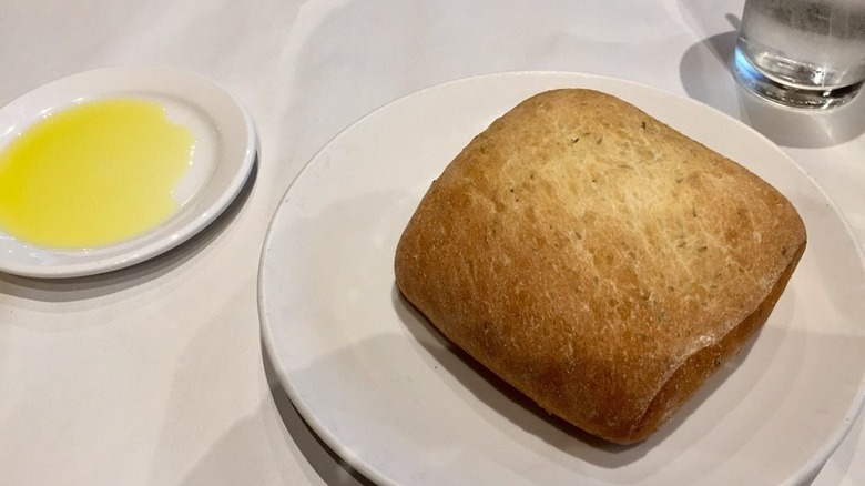 Square bread beside dipping oil