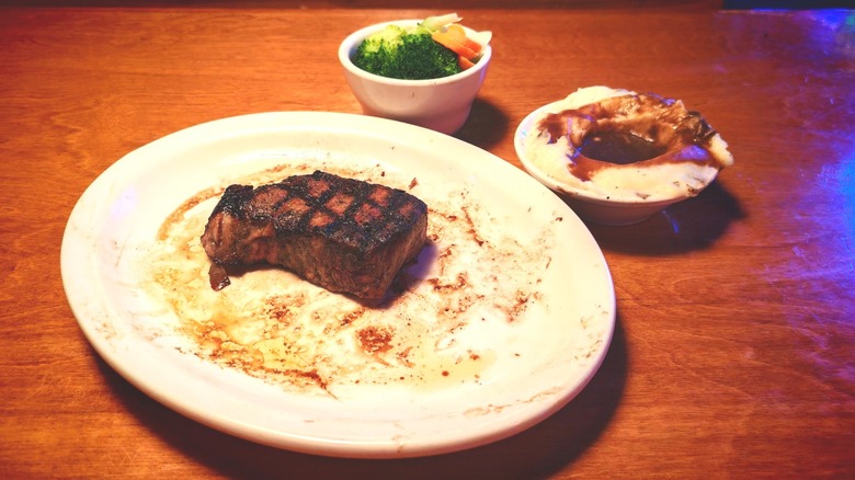 plated Texas Roadhouse New York strip with broccoli and mashed potatoes