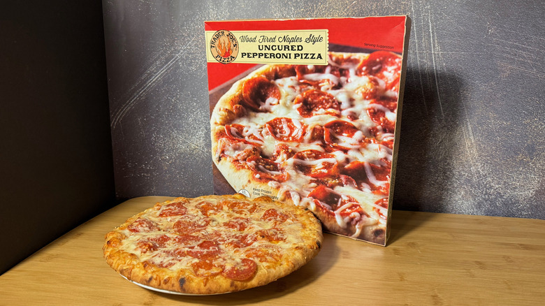 Baked pepperoni pizza in front of its box