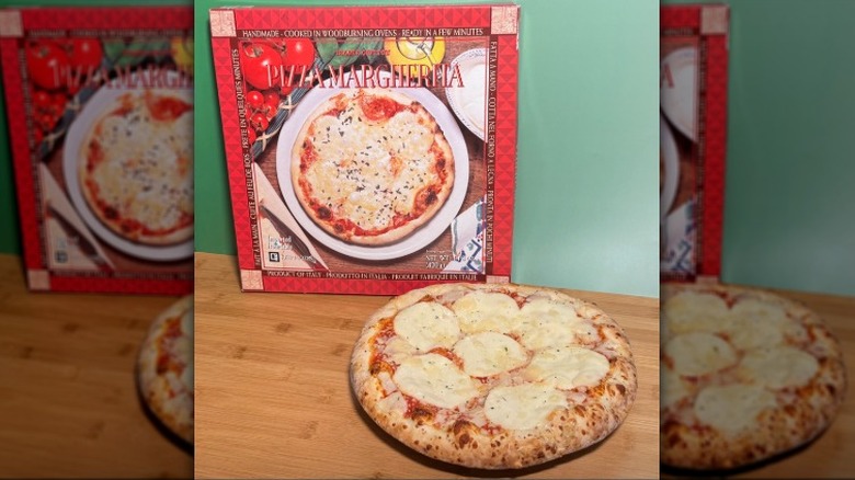 Fresh Margherita pizza in front of its box