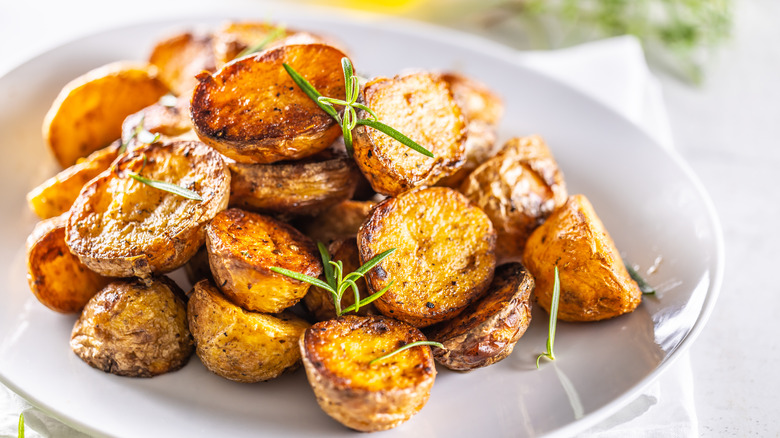 A pile of freshly roasted potatoes on a plate