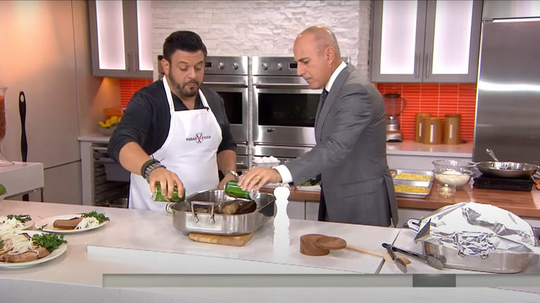 adam richman pouring ginger ale over meat