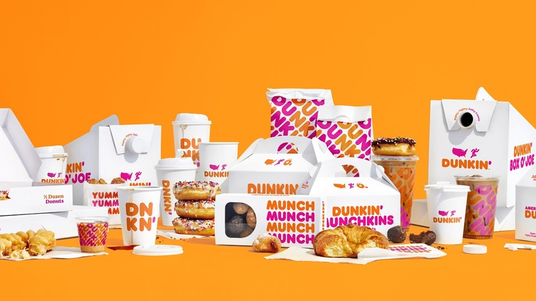 variety of Dunkin' menu items with branded boxes and bags