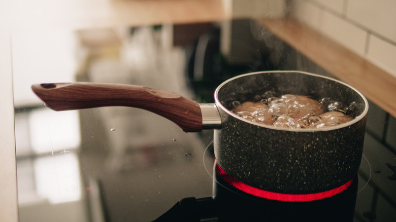 Eggs boiling in a pot of water