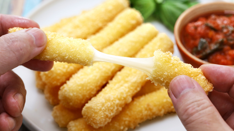 Close-up of a mozzarella stick being pulled apart