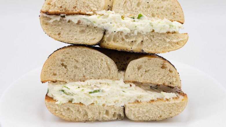 sliced bagel filled with scallion cream cheese