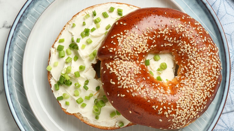 scallions and cream cheese spread on a bagel