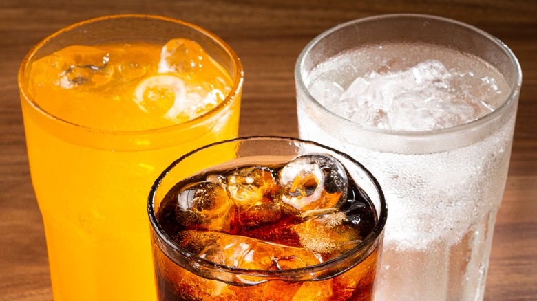 Close-up of three drinks with ice cubes