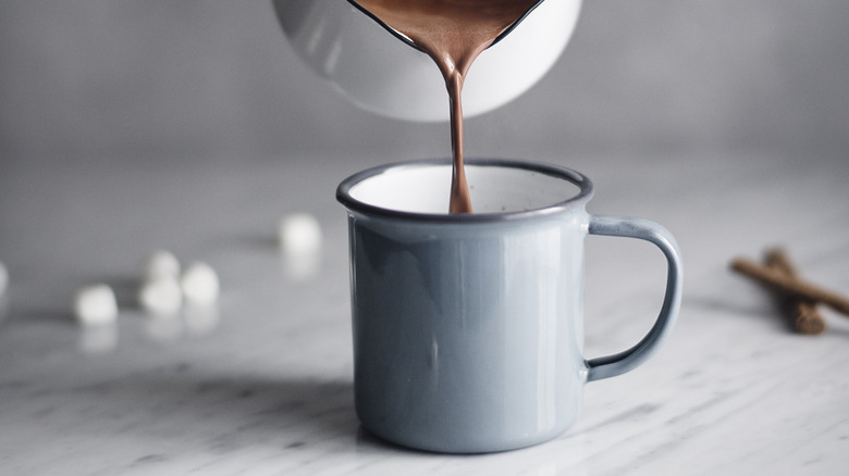 Hot chocolate pouring into mug.