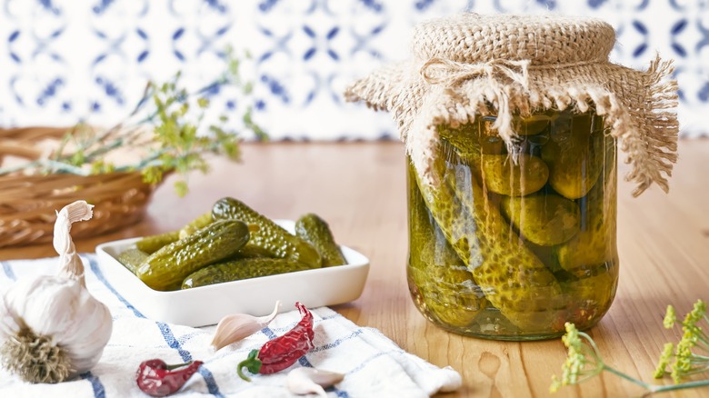 Jar of pickles next to plated pickles 