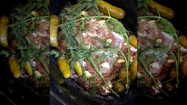 Pickle pot roast with dill sprigs