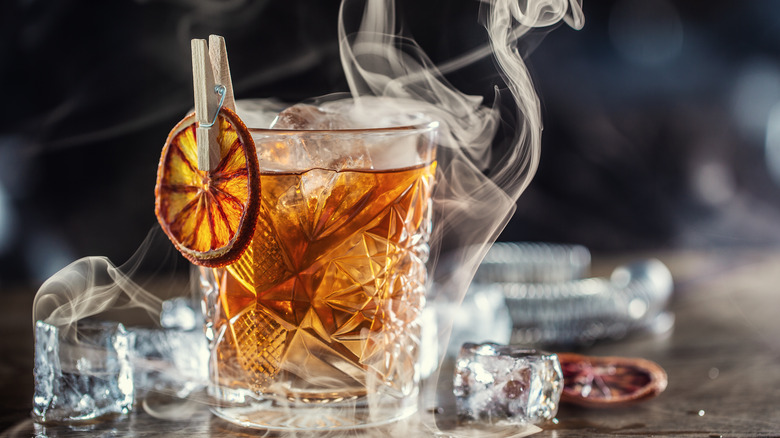 Smoked cocktail with dried fruit garnish