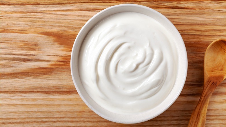 Bowl of sour cream with spoon 