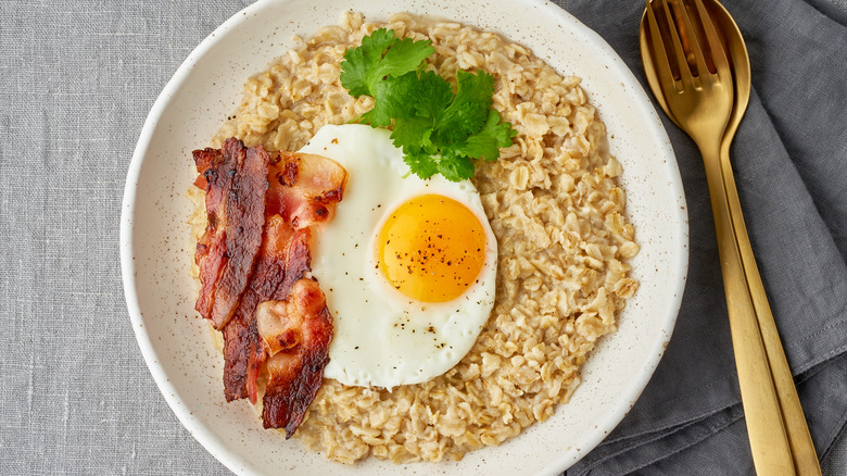 Bowl of oatmeal with eggs and bacon