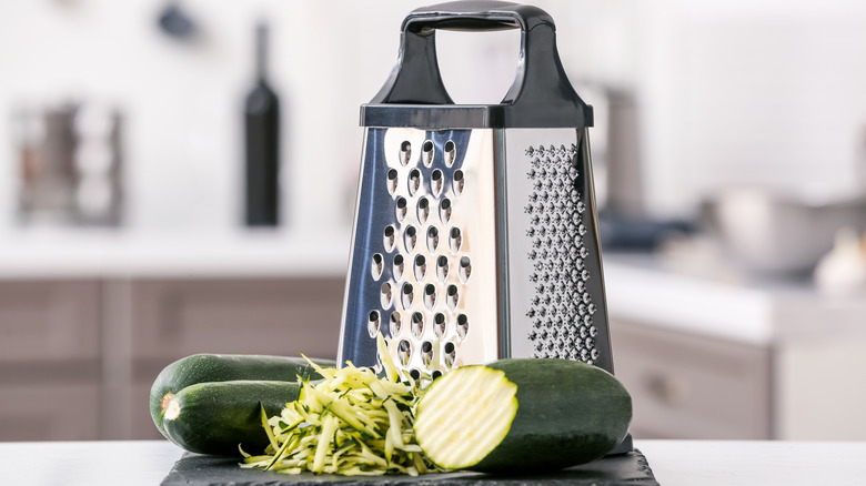 Zucchini beside box grater