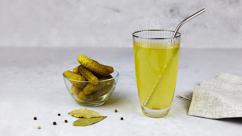 pickle juice in glass with small pickles