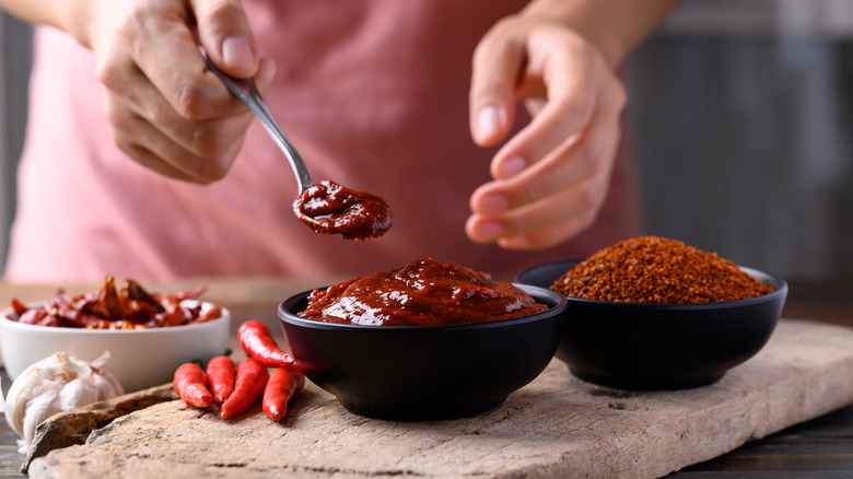 person cooking with gochujang