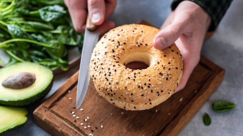 Person cutting bagel