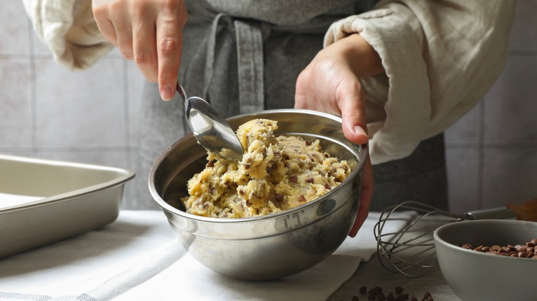 Person mixing raw cookie dough