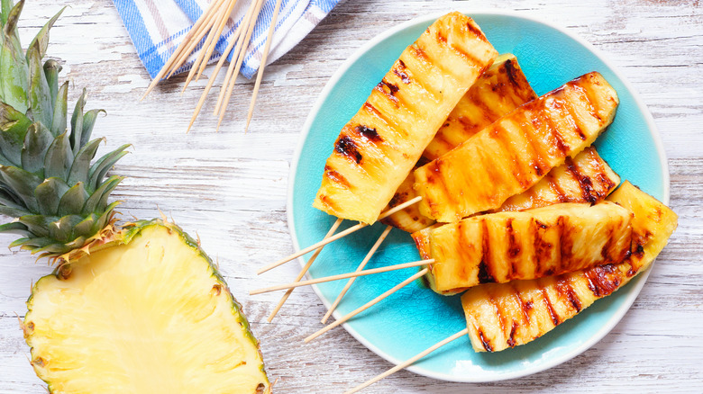 halved pineapple and grilled strips