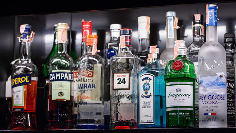 various bottles of hard liquor on a dark background