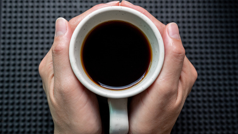 brewed coffee mug in hands