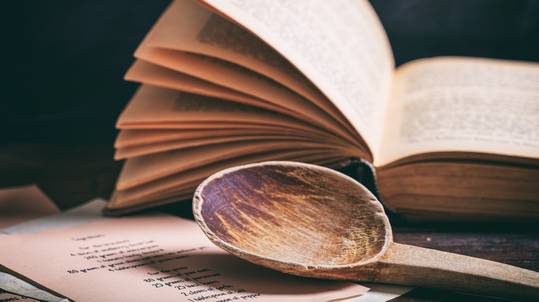 wooden spoon by old cookbook