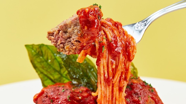 Fork holding meatball and spaghetti