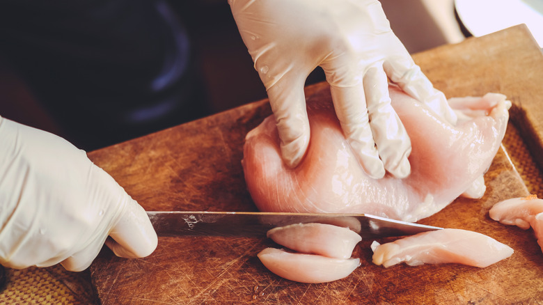 raw chicken sliced on board