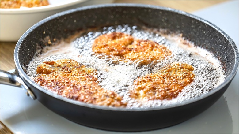 pieces of breading meat frying