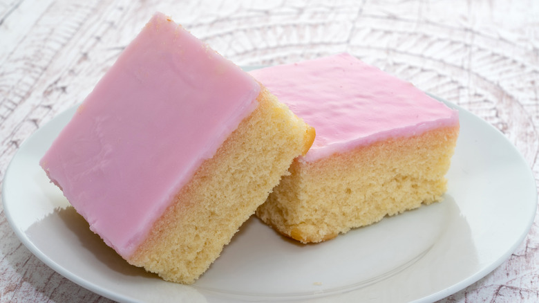 two pieces of Tottenham cake on a white plate