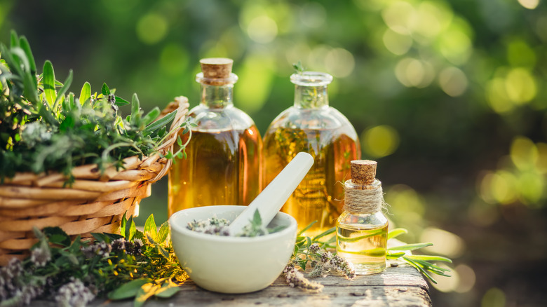 mortar, pestle, herbs, and oil