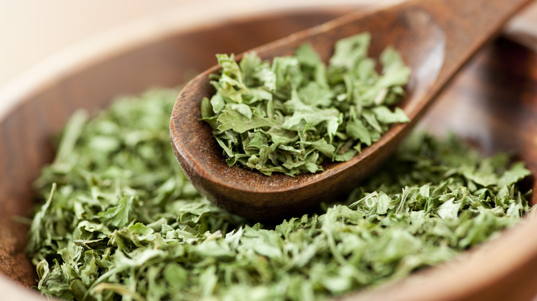 bowl and spoon of dried parsley