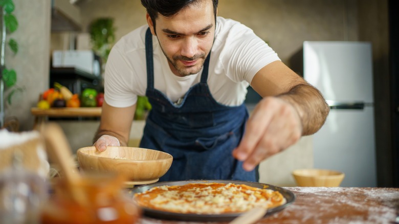 man making pizza