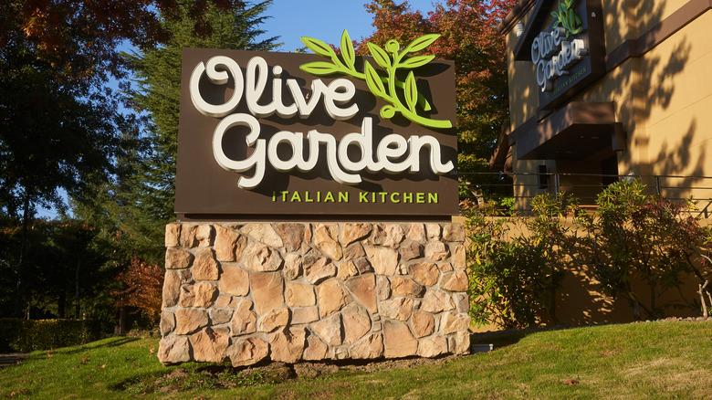 Olive garden sign on grassy hill