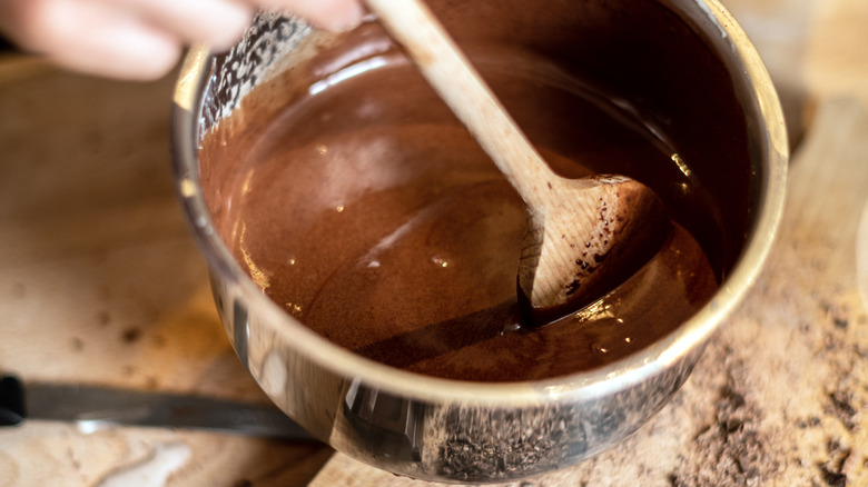 Wooden spoon in melted chocolate