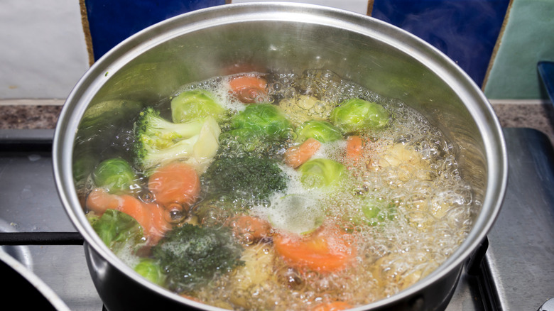 Vegetables boiling in pan