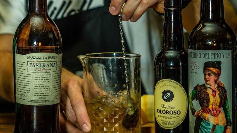 bottles of sherry with mixing glass